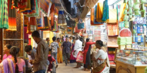 A bustling market scene filled with vibrant cloths hanging from the ceiling, showcasing a variety of colors and patterns.