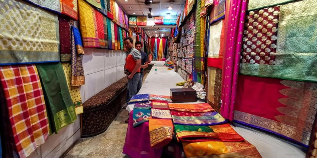 colorful saris hanging on both sides.